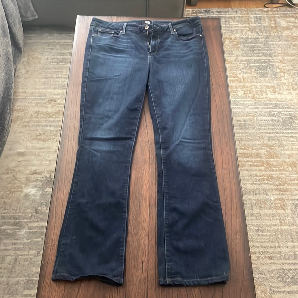 Paige size 34 jeans with light factory wear.
